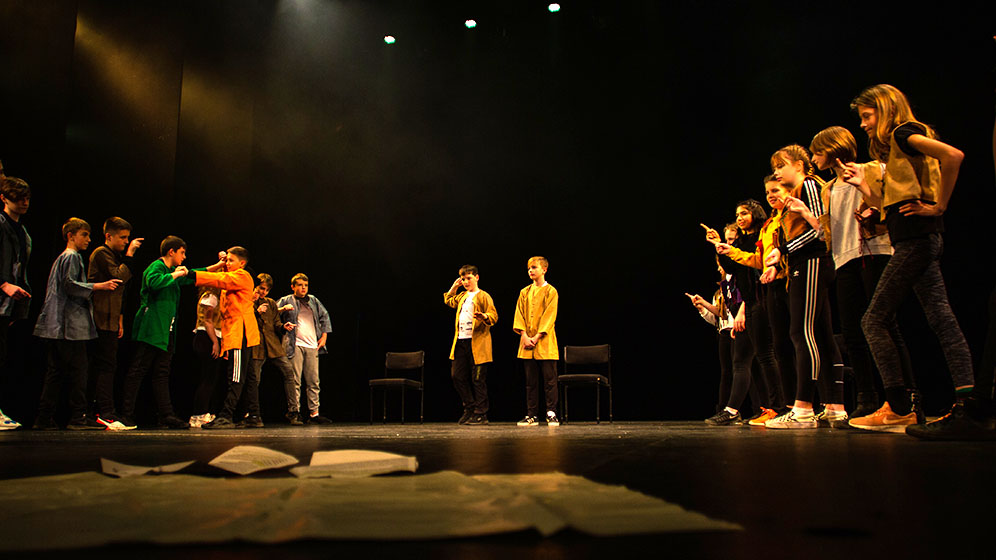 School children performing in a theatre